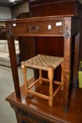 A late Victorian golden oak side table having frieze drawer and later brass embelishments, and a