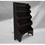 A 19th Century stained frame waterfall bookcase, in the naive style having shaped ends and feet,