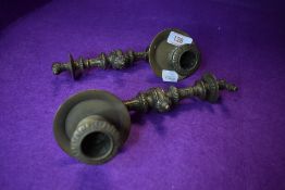 A pair of antique brass carriage or piano candle sticks with classical design