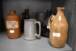 Two pewter tankards a pair of brown wine bottles and studio pottery vessel