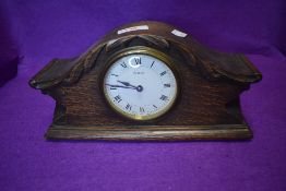 An oak cased mantle clock having 8 day movement