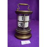 A 1930's desktop flip ticket clock by Ever Ready the Chronos Clock having glass and brass case