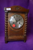 An oak cased bracket clock having brass face dial and chime