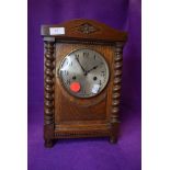 An oak cased bracket clock having brass face dial and chime