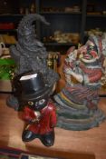 Two cast iron door stops in the form of Punch and Judy also a small cast money box