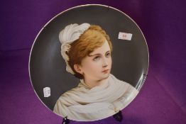 A fine porcelain plate having a hand decorated portrait of Russian styled lady