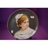 A fine porcelain plate having a hand decorated portrait of Russian styled lady