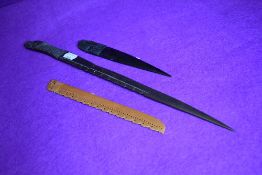 Three African carved tribal style letter openers including box wood and ebony