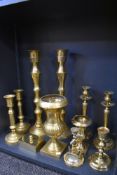 Three sets of brass cast candle sticks also and anchor styled cnadle stick and two mantle urns