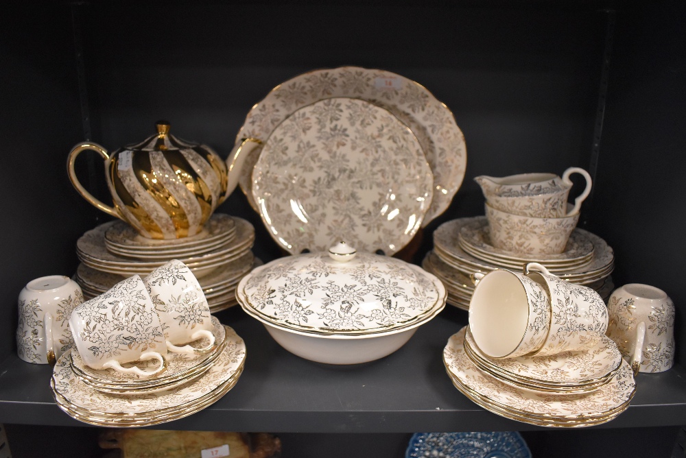 A part dinner and tea service by Washington Pottery, Hanley, in a cream ground a gilt design