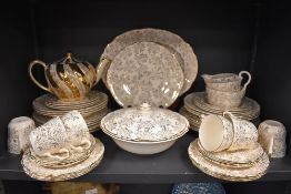 A part dinner and tea service by Washington Pottery, Hanley, in a cream ground a gilt design