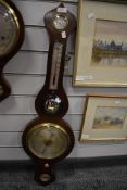 An antique banjo style barometer having a mahogany case with bulls eye mirror