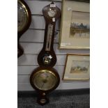 An antique banjo style barometer having a mahogany case with bulls eye mirror