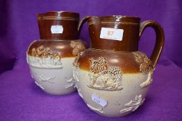 Two earthen ware pottery jugs with traditional hunting scenes