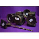 Four early 20th century motor or cycle lamps including Courier, H Miller and Lucas