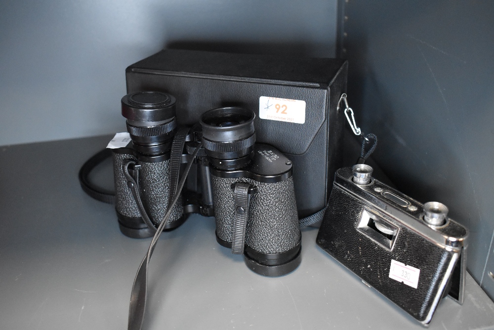 A pair of fold away pocket binoculars and a similar pair by Boots 8x30 with case