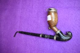 A Victorian opium smokers pipe having ebony shaft with a burr wood formed bowl