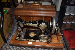 A 1920's English JONES FAMILY C.S. Type 7 Queen Alexandra Sewing Machine with wooden case