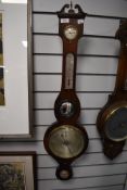 An antique banjo style barometer having a rose wood case and bulls eye mirror