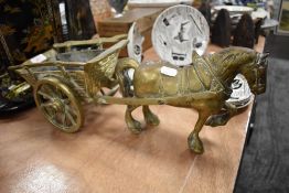 A brass cast figure of a horse and cart