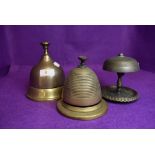 Three desk top brass bell ringers in various forms including bee hive, bell form and art nouveau