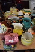 A selection of various ceramic water jugs including art deco designs and Grays pottery