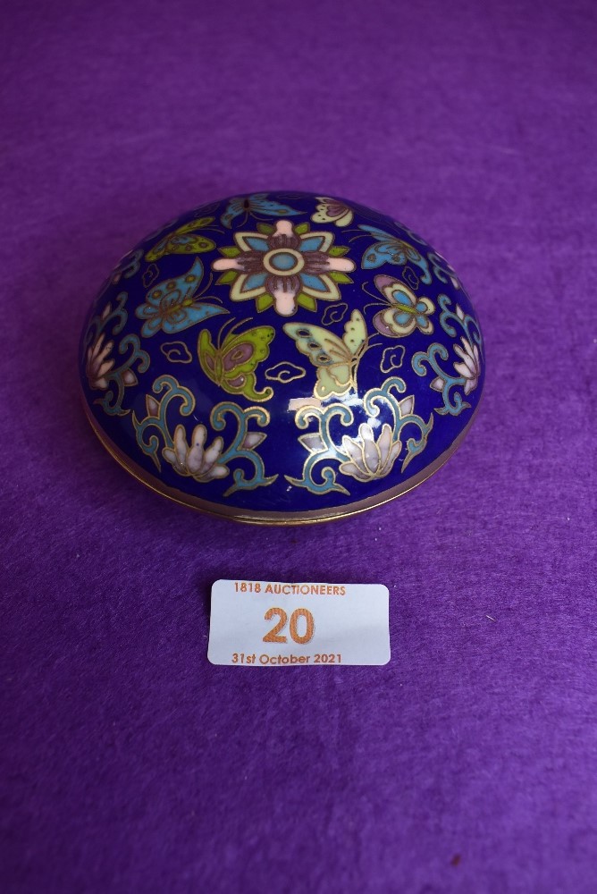 A lidded cloisonne trinket dish in a deep cobalt blue ground with floral design