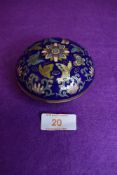 A lidded cloisonne trinket dish in a deep cobalt blue ground with floral design