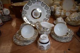 A part tea service by Dubany in a gilt and white ground design bone China 22kt decoration