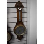 An antique banjo style barometer having an oak case and mercury filled