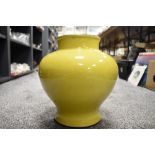 A large Chinese yellow glaze squat form vase having porcelain body with black rim 28cm tall