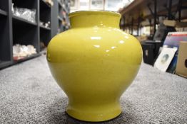 A large Chinese yellow glaze squat form vase having porcelain body with black rim 28cm tall