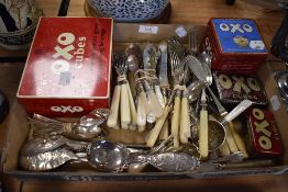 A selection of table wares and cutlery including mother of pearl handled and Oxo cube tins