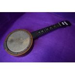 A folk art style banjo/ukulele