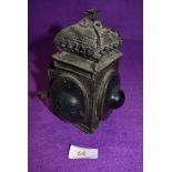 An antique brass cased candle lantern or chamber stick having green bullseye glass windows,