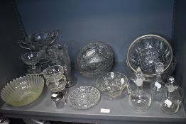 A selection of clear cut and pressed glass wares including sauce decanters