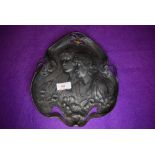 An art nouveau design metal pewter serving tray decorated with lily leaf and portrait design