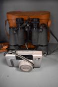 A canon sureshot Z135 and a pair of King 10x50 binoculars with leather case