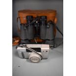 A canon sureshot Z135 and a pair of King 10x50 binoculars with leather case