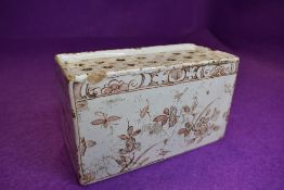 An antique possibly late Georgian delft Dutch flower brick decorated with flowers and insects 16cm