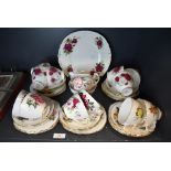 A part tea service by Colclough having various floral designs twelve tea cup and saucer sets plus