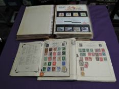 An album of mainly GB Presentation Packs along with two World Stamp Albums