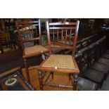 A pair of Victorian mahogany bedroom chairs having cane seats