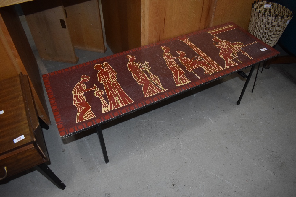 A vintage coffee table in the Piper style, having Greco-Romanesque decoration, approx. 115 x 38cm