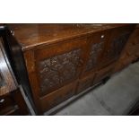 A late 19th or early 20th Century carved oak sideboard of on bulbous legs, ledge back, double