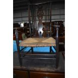 A 19th Century stained fram spindle and wheel back rush seated carver chair