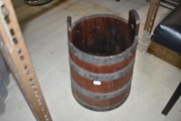 A vintage oak and metal bound milking pail