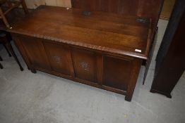 A nice quality early 20th Century oak blanket box having rose motif to the centre two of the four