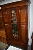 A Victorian mahogany three piece bedroom suit comprising mirror door wardrobe, dressing table and