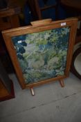An early 20th Century stripped frame fire screen having tapestry screen
